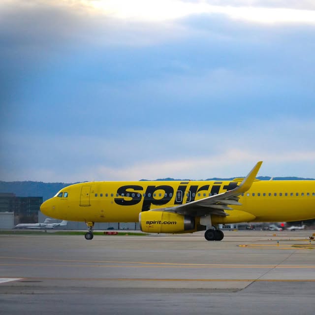 Yellow Spirit Airlines jet taxiing past the camera