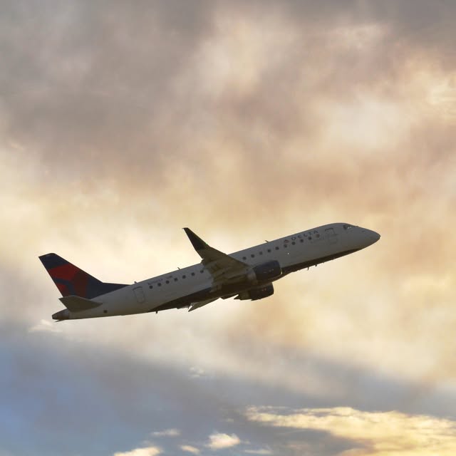 Delta regional jet climbing into backlit clouds